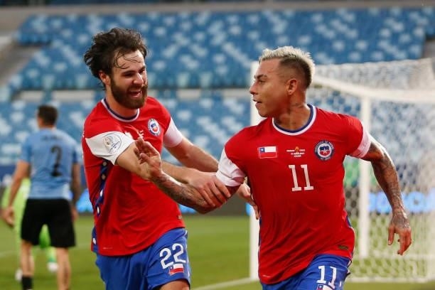 Eduardo Vargas of Chile celebrates with teammate Ben Brereton after scoring the first goal of his team during a group A match between Uruguay and...