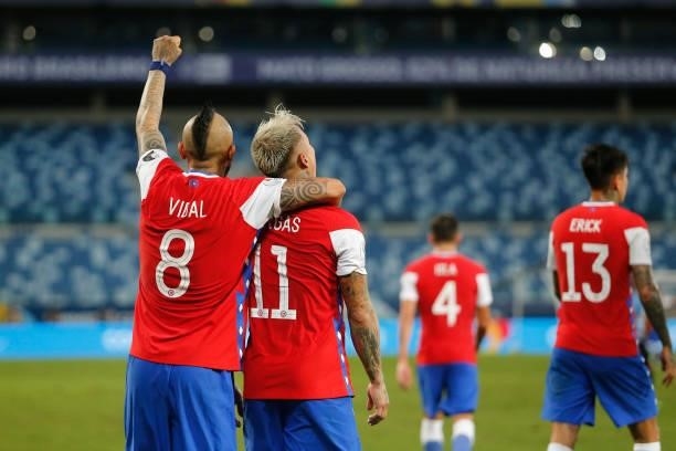 Eduardo Vargas of Chile celebrates with teammate Arturo Vidal after scoring the first goal of his team during a group A match between Uruguay and...