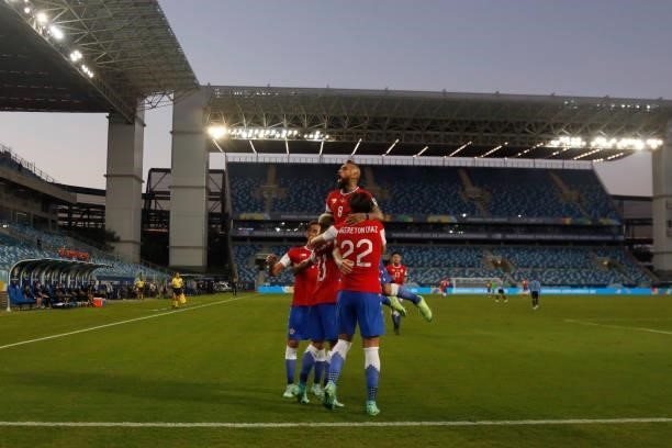 Eduardo Vargas of Chile celebrates with teammates Arturo Vidal and Ben Brereton after scoring the first goal of his team during a group A match...