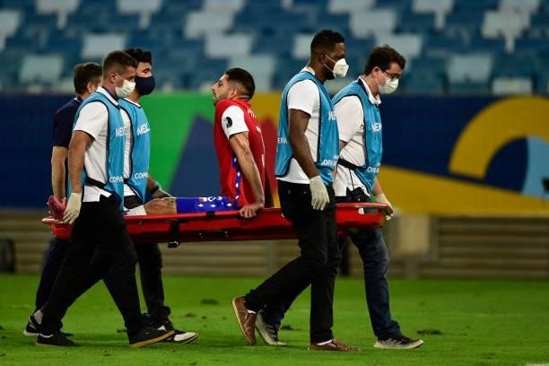 Guillermo Maripán of Chile leaves the field after being injured during a group A match between Uruguay and Chile as part of Conmebol Copa America...