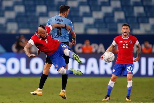 Arturo Vidal of Chile competes for the ball with Matias Vecino of Uruguay during a group A match between Uruguay and Chile as part of Conmebol Copa...