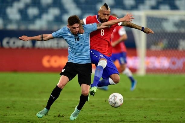 Federico Valverde of Uruguay competes for the ball with Arturo Vidal of Chile during a group A match between Uruguay and Chile as part of Conmebol...