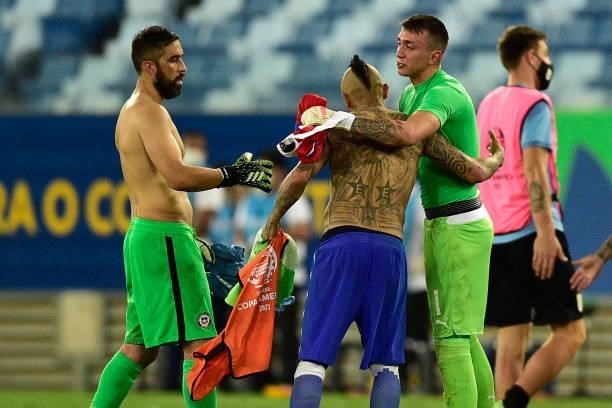 Goalkeeper Claudio Bravo and Arturo Vidal of Chile greet Fernando Muslera goalkeeper of Uruguay during a group A match between Uruguay and Chile as...