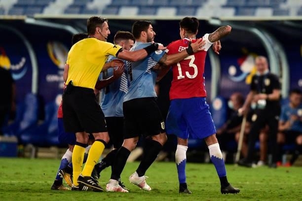 Erick Pulgar of Chile fights with Luis Suarez of Uruguay as referee Raphael Claus tries to calm down during a group A match between Uruguay and Chile...