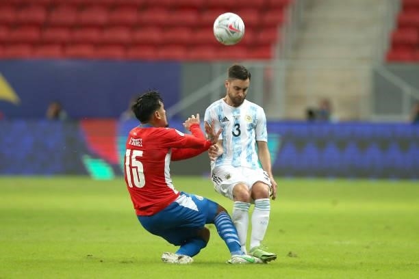 Gustavo Gomez of Paraguay competes for the ball with Nicolas Tagliafico of Argentina during a group A match between Argentina and Paraguay as part of...