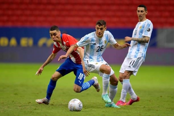 Miguel Almiron of Paraguay competes for the ball with Nahuel Molina of Argentina during a group A match between Argentina and Paraguay as part of...
