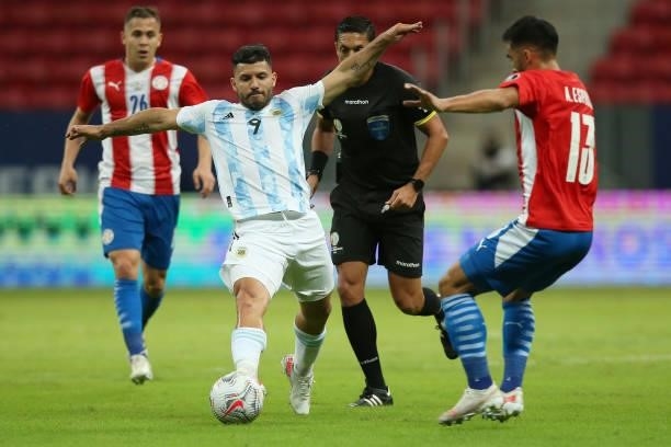 Sergio Agüero of Argentina competes for the ball with Alberto Espinola of Paraguay during a group A match between Argentina and Paraguay as part of...
