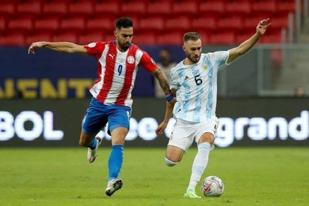 Gabriel Avalos of Paraguay competes for the ball with German Pezzella of Argentina during a group A match between Argentina and Paraguay as part of...