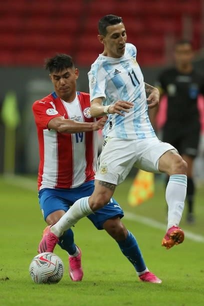 Santiago Arzamendia of Paraguay competes for the ball with Angel Di Maria of Argentina during a group A match between Argentina and Paraguay as part...