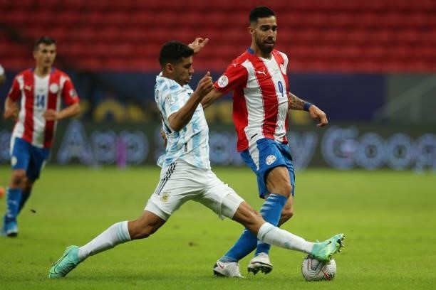 Joaquín Correa of Argentina competes for the ball with Gabriel Avalos of Paraguay during a group A match between Argentina and Paraguay as part of...