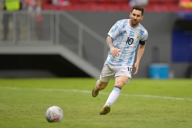 Lionel Messi of Argentina looks at the ball during a group A match between Argentina and Paraguay as part of Conmebol Copa America Brazil 2021 at...