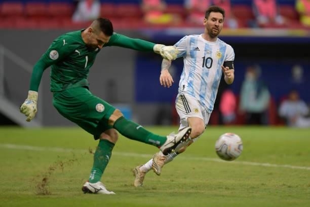 Lionel Messi of Argentina looks on as Antony Silva goalkeeper of Paraguay kicks the ball during a group A match between Argentina and Paraguay as...