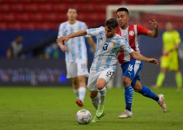 Nicolas Tagliafico of Argentina competes for the ball with Ángel Cardozo of Paraguay during a group A match between Argentina and Paraguay as part of...