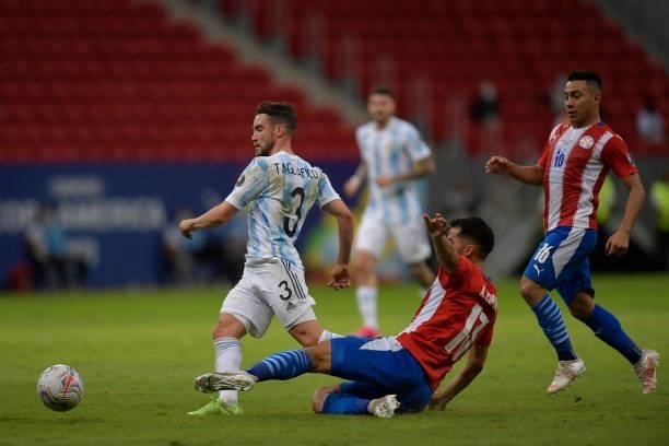 Nicolas Tagliafico of Argentina competes for the ball with Alberto Espinola of Paraguay during a group A match between Argentina and Paraguay as part...