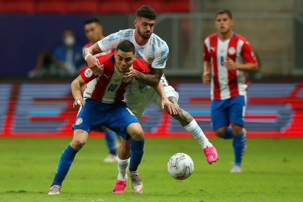 Miguel Almiron of Paraguay competes for the ball with Rodrigo De Paul of Argentina during a group A match between Argentina and Paraguay as part of...