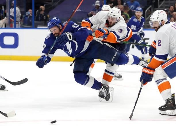 Alex Killorn of the Tampa Bay Lightning is checked by Adam Pelech of the New York Islanders during the third period in Game Five of the Stanley Cup...