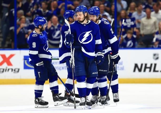 Luke Schenn of the Tampa Bay Lightning is congratulated by his teammates after scoring a goal against the New York Islanders during the third period...