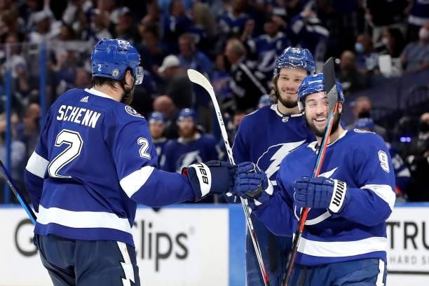 Luke Schenn of the Tampa Bay Lightning is congratulated by Tyler Johnson after scoring a goal against the New York Islanders during the third period...