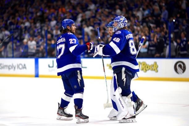 Andrei Vasilevskiy of the Tampa Bay Lightning is congratulated by Ryan McDonagh after the team's 8-0 victory against the New York Islanders in Game...