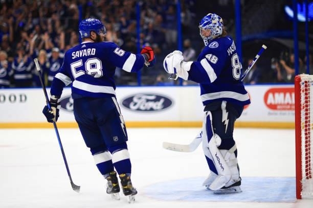 Andrei Vasilevskiy of the Tampa Bay Lightning is congratulated by David Savard after the team's 8-0 victory against the New York Islanders in Game...