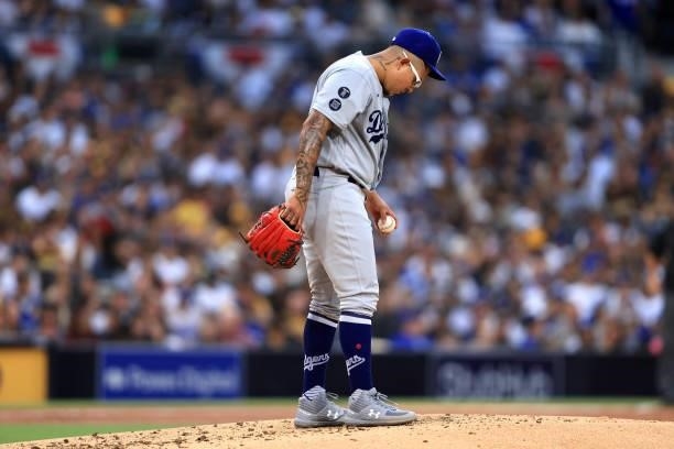 Julio Urias of the Los Angeles Dodgers looks on after allowing three-run homerun to Manny Machado of the San Diego Padres during the first inning of...