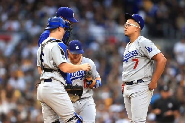 Will Smith, Justin Turner and pitching coach Mark Prior talk with Julio Urias of the Los Angeles Dodgers looks on he allowed a three-run homerun to...