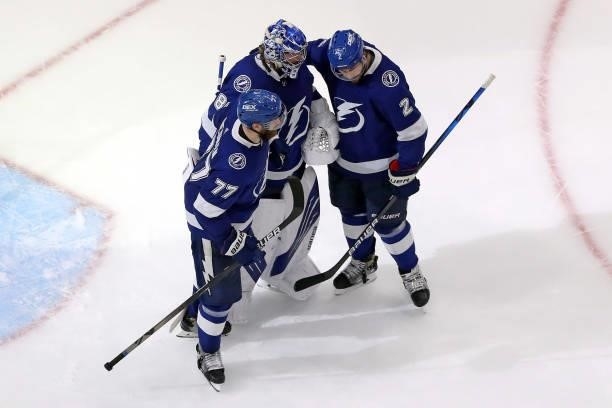 Andrei Vasilevskiy of the Tampa Bay Lightning is congratulated by Victor Hedman and Luke Schenn after their 8-0 shutout victory against the New York...
