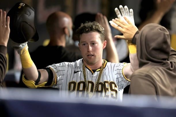 Jake Cronenworth of the San Diego Padres reacts in the dugout after hitting a two-run homerun during the fifth inning of a game against the Los...