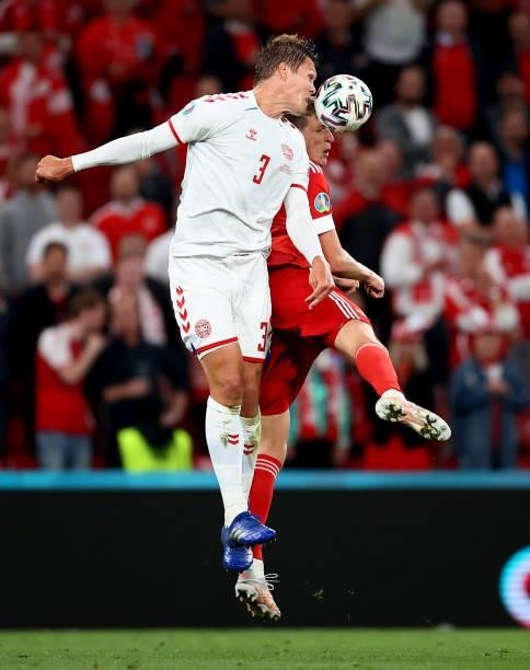 Jannik Vestergaard of Denmark challenges Aleksandr Sobolev of Russia during the UEFA Euro 2020 Championship Group B match between Russia and Denmark...