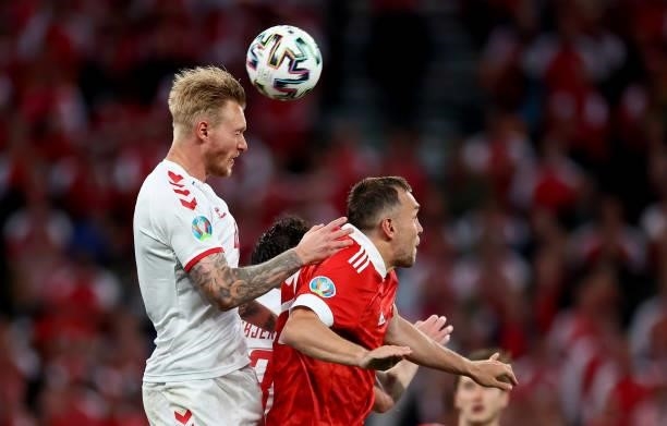 Simon Kjær of Denmark challenges Artem Dzyuba of Russia during the UEFA Euro 2020 Championship Group B match between Russia and Denmark at Parken...