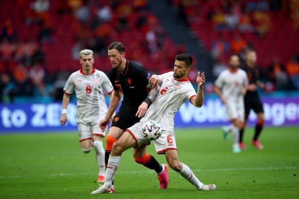 Visar Musliu of North Macedonia battles with Wout Weghorst of Netherlands during the UEFA Euro 2020 Championship Group C match between North...