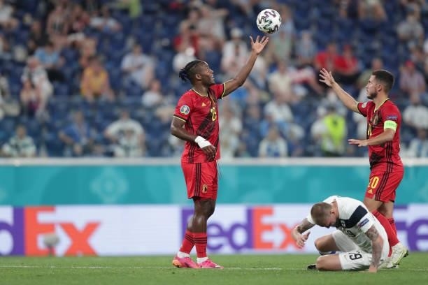 Jeremy Doku of Belgium passes the ball to his teammate Eden Hazard as Joni Kauko of Finland reacts during the UEFA Euro 2020 Championship Group B...