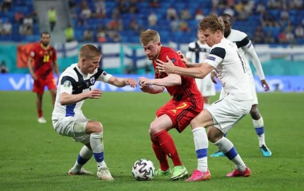 Kevin De Bruyne of Belgium battles for the ball with Jere Uronen of Finland and Rasmus Schuller of Finland during the UEFA Euro 2020 Championship...