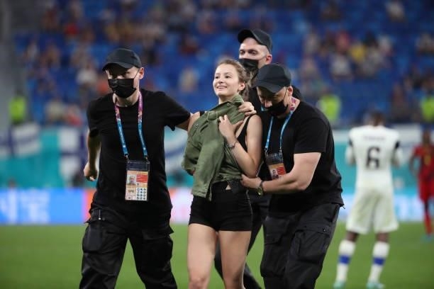 Supporter is escorted by three chaperones during the UEFA Euro 2020 Championship Group B match between Finland and Belgium at Saint Petersburg...