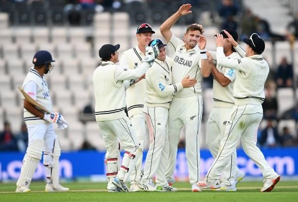 Tim Southee of New Zealand celebrates taking the wicket of Rohit Sharma of India with teammates during Day 5 of the ICC World Test Championship Final...
