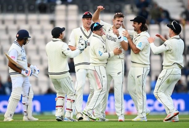 Tim Southee of New Zealand celebrates taking the wicket of Rohit Sharma of India with teammates during Day 5 of the ICC World Test Championship Final...