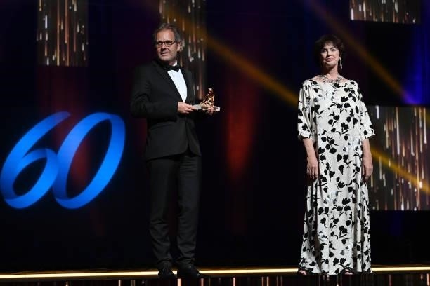 Stephane Goel poses with the Best Documentary Film Golden Nymph award for « Citizen Nobel » next to Anny Duperey on stage during the closing ceremony...