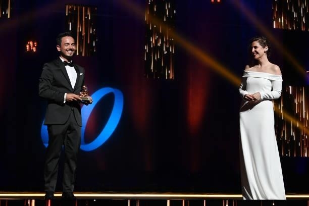 André Carvalho Ramos poses with the Best News Documentary Golden Nymph award for « The Diagnosis: COVID-19 » on stage next to Laura Ledesma during...