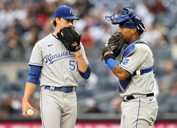 Brady Singer of the Kansas City Royals talks with Salvador Perez in the second inning against the New York Yankees at Yankee Stadium on June 22, 2021...