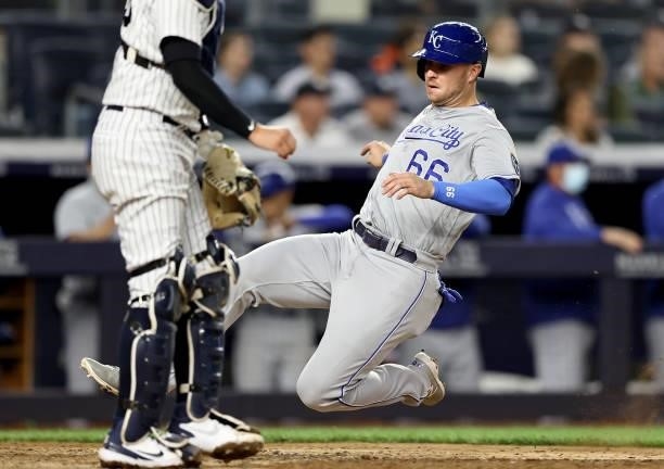 Ryan O'Hearn of the Kansas City Royals slides home safely in the eighth inning against the New York Yankees at Yankee Stadium on June 22, 2021 in the...