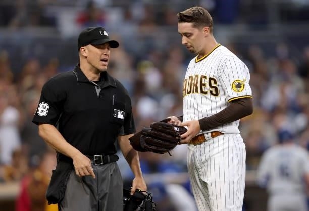 Home plate umpire Chris Segal checks Blake Snell of the San Diego Padres for illegal substances during the first inning of a game against the Los...