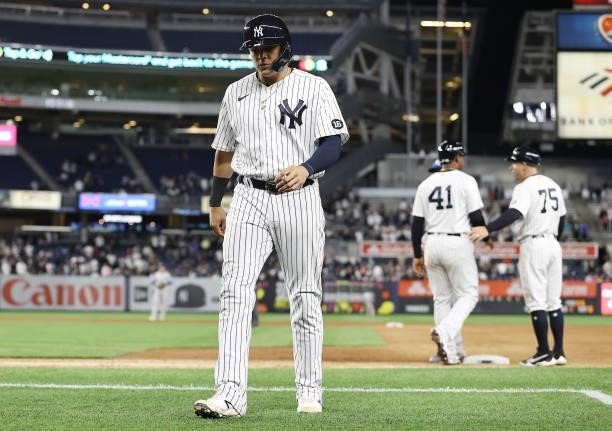 Gio Urshela of the New York Yankees walks back to the dugout after Miguel Andujar enters the game to pinch run in the ninth inning against the Kansas...
