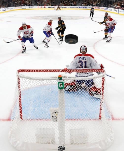 The puck sails above the net as Carey Price of the Montreal Canadiens defends against the Vegas Golden Knights in the second period in Game Five of...