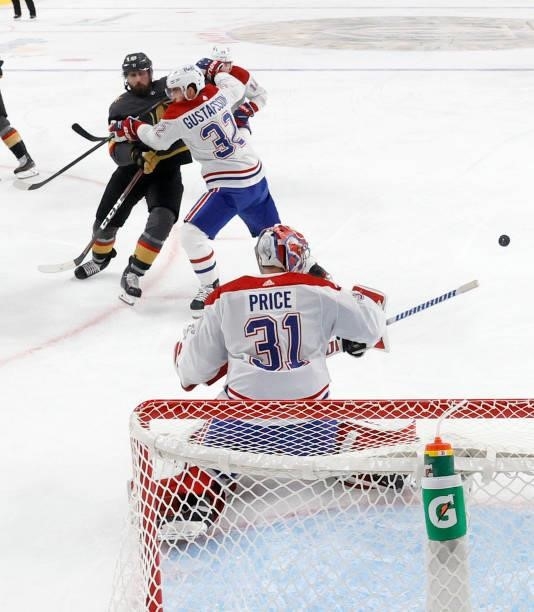 Carey Price of the Montreal Canadiens blocks a shot by Alex Tuch of the Vegas Golden Knights as Erik Gustafsson of the Canadiens defends in the...