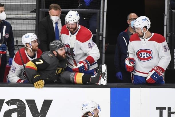 Jon Merrill and Joel Edmundson of the Montreal Canadiens help Alex Pietrangelo of the Vegas Golden Knights out of their bench after he was checked...