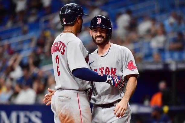 Xander Bogaerts and Connor Wong of the Boston Red Sox celebrate after scoring in the 11th inning against the Tampa Bay Rays at Tropicana Field on...