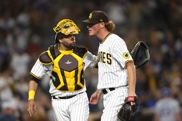 Webster Rivas talks with Mason Thompson of the San Diego Padres pitches in his major league debut during the eighth inning of a game against the Los...