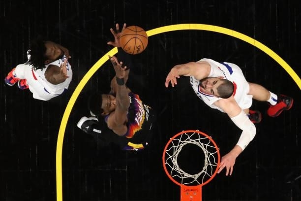 Deandre Ayton of the Phoenix Suns catches the ball before a slam dunk over Ivica Zubac and Patrick Beverley of the LA Clippers during the second half...