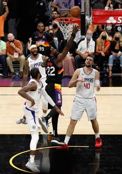 Deandre Ayton of the Phoenix Suns puts up a shot over Paul George and Ivica Zubac of the LA Clippers during the second half of game two of the...
