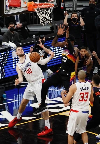 Deandre Ayton of the Phoenix Suns slam dunks the ball over Ivica Zubac of the LA Clippers during the final second of game two of the Western...